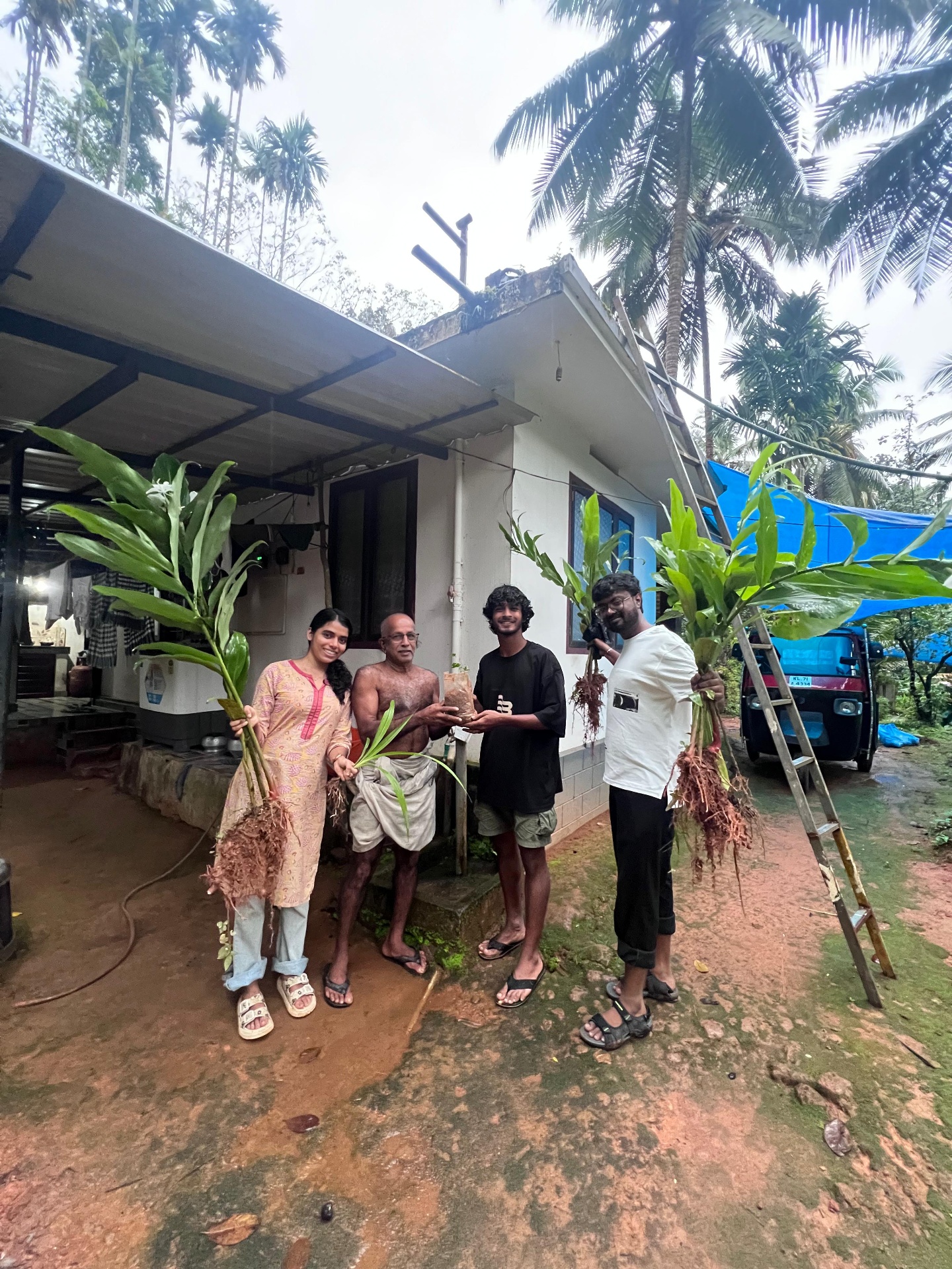 Ignite Foundation team with a community elder, sharing native plant saplings in Kerala