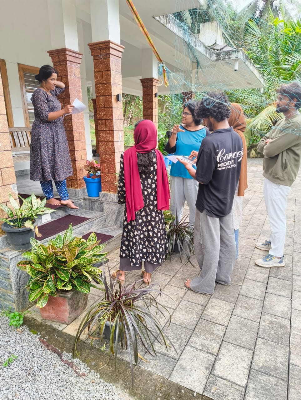 Community learning session on the porch of the Ashram
